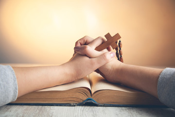 woman hand wooden cross with book