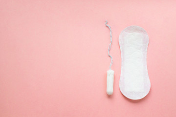 women intimate hygiene products - sanitary pad and tampon on pink background. - obrazy, fototapety, plakaty