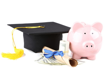 Piggybank with graduation cap, diploma and dollar banknotes isolated on white background