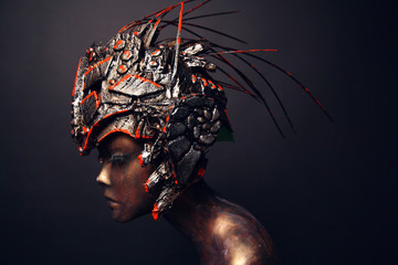 Bronze head of mannequin in decorated bronze kokoshnick, dark studio background
