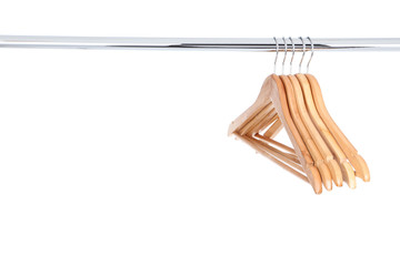 Wooden hangers hanging on white background