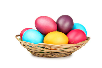 Easter eggs in basket isolated on white background