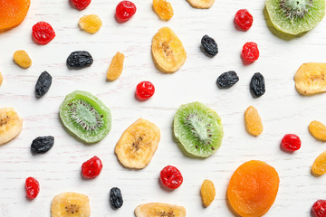 Flat lay composition with different dried fruits on wooden background. Healthy lifestyle