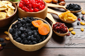 Composition with different dried fruits on wooden background. Healthy lifestyle