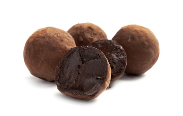Delicious raw chocolate truffles on white background