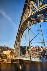 View of the historic city of Porto, Portugal with the Dom Luiz bridge. A metro train can be seen on the bridge