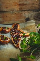 pear baked on butter with cinnamon and sugar spread with hot dark chocolate with the addition of chopped leaves mints