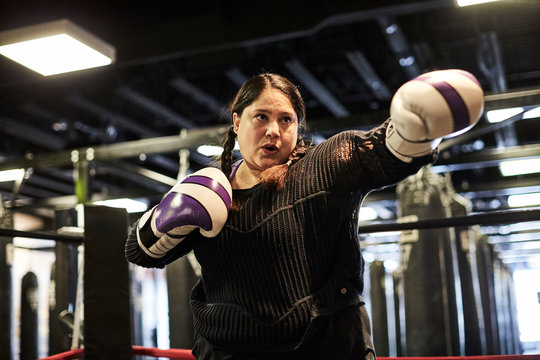 A female boxer boxing while training in the gym