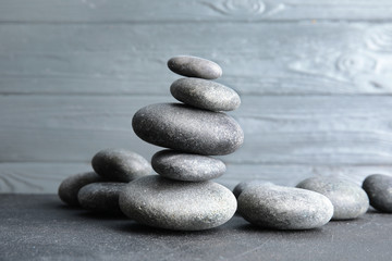 Stacked zen stones on table against wooden background