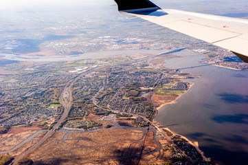 Aerial view of New York City from an airplane looking over the wing showing New Jersey.