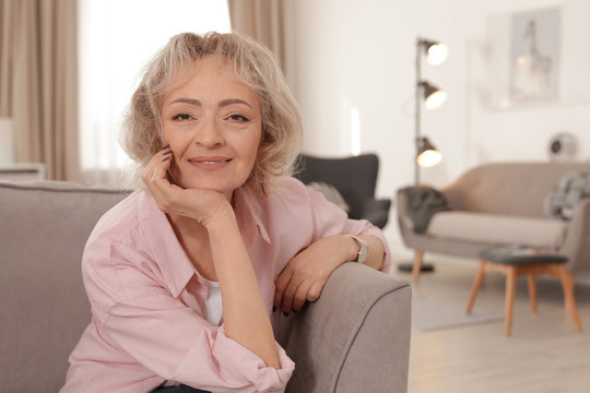 Portrait of mature woman in living room