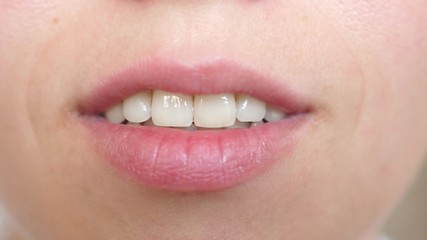 kiss lips Close-up. beautiful smile of young woman. girl smiling teeth and lips close-up.