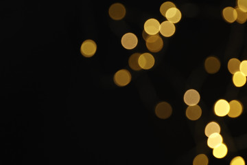 Beautiful golden lights on dark background. Bokeh effect