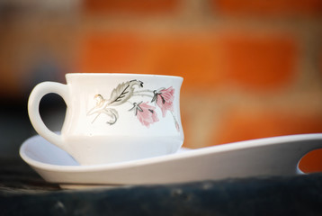 India - March 12, 2019: A white cup of tea in a red background