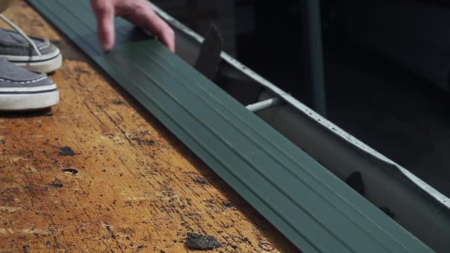 Roof contractor installing drip edge on unfinished home roof