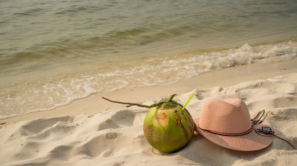 Phu Quoc island with coconut,legs and hat sea on beautiful white sand with crystal clear sea and palms as a travel concept background