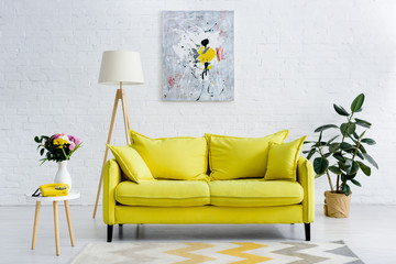interior of cozy living room with bright yellow elements, decor and retro telephone