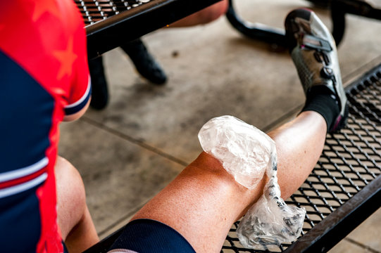 A bag of ice on a woman's knee during a break from a bike ride.