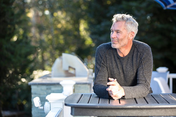 Portrait of man sitting at outdoor table