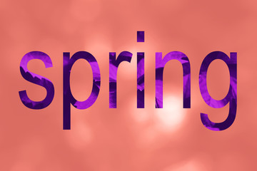 Coral color bokeh background with word Spring
