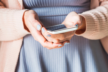 Woman using white smartphone. Pastel colors