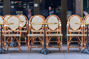Rows of traditional Chairs of a Street Cafe in France, french furniture in a Street 