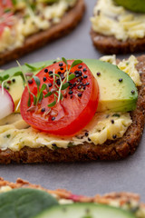 Sandwiches with cream cheese, vegetables and salami.