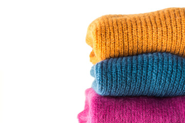 Pile of color woolen sweaters