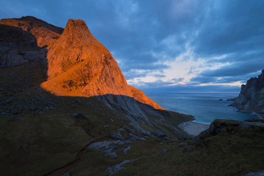 Sunrise over Storskiva mountain peak and Bunes beach