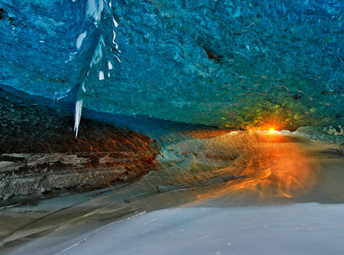 View of opening of ice cave during sunset