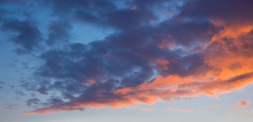Blue and orange clouds in the sky during the sunset. Evening sky_