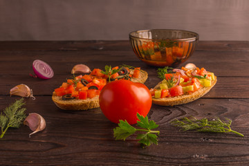 Salad sandwiches, tomato salad with olives and cucumber. Greenery.