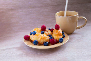 fresh juicy summer berries raspberry and blueberry with drops of honey in a natural beige cotton cloth. 