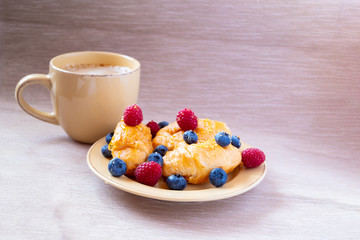 fresh juicy summer berries raspberry and blueberry with drops of honey in a natural beige cotton cloth. 