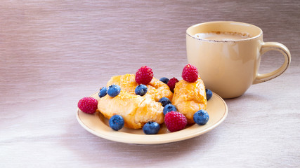fresh juicy summer berries raspberry and blueberry with drops of honey in a natural beige cotton cloth. 