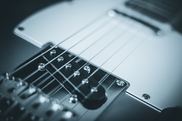 Guitar electric rock background. Single coil pickup close-up, shallow depth of field. Blue toned filter