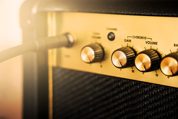 Guitar electric amplifier. Rock music overdrive effect. Volume control knob up to the max. Shallow depth of field