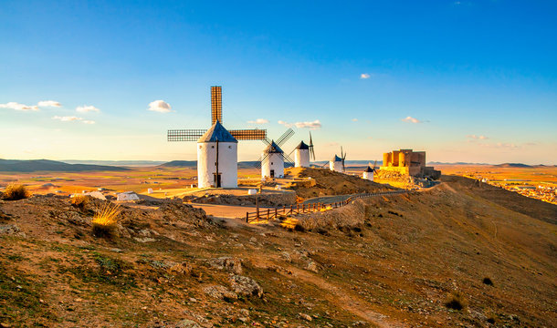 Spanish windmills and medieval castle on a hill in Consuegra, Toledo, Spain.