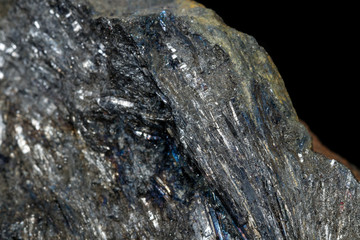 Macro of a stone Stibnite mineral on a black background