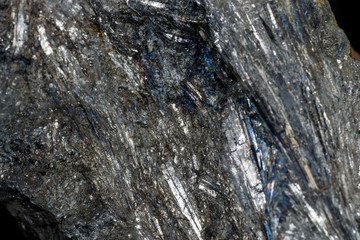 Macro of a stone Stibnite mineral on a black background
