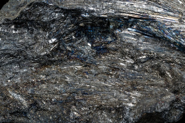 Macro of a stone Stibnite mineral on a black background