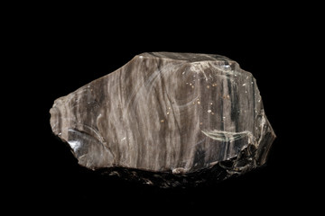 Macro stone mineral obsidian on a black background