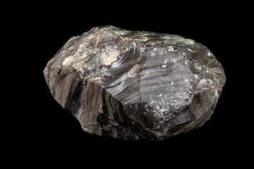 Macro stone mineral obsidian on a black background