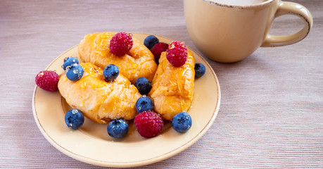 fresh juicy summer berries raspberry and blueberry with drops of honey in a natural beige cotton cloth. 