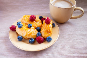 fresh juicy summer berries raspberry and blueberry with drops of honey in a natural beige cotton cloth. 