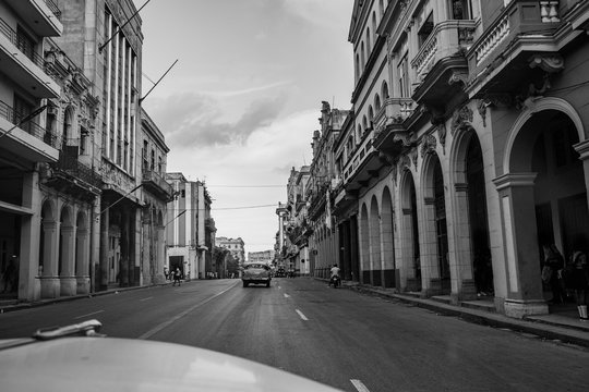 Driving dow a main street with colonial looking bulidings. Havanna, Cuba
