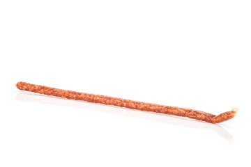 One whole spicy salami stick tyrolini isolated on white background