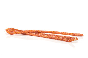 Group of three whole spicy salami stick tyrolini isolated on white background