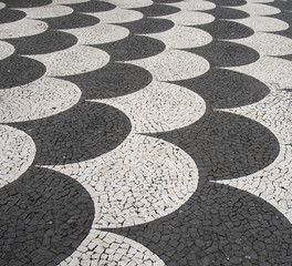 traditional portugal black and white fish scale pattern tiled cobblestone sidewalk in funchal madeira © Philip J Openshaw 