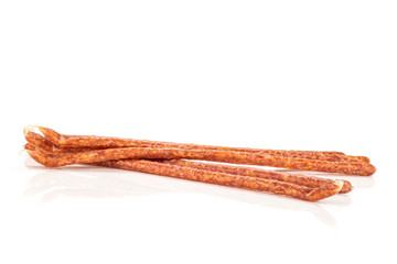 Group of five whole spicy salami stick tyrolini isolated on white background